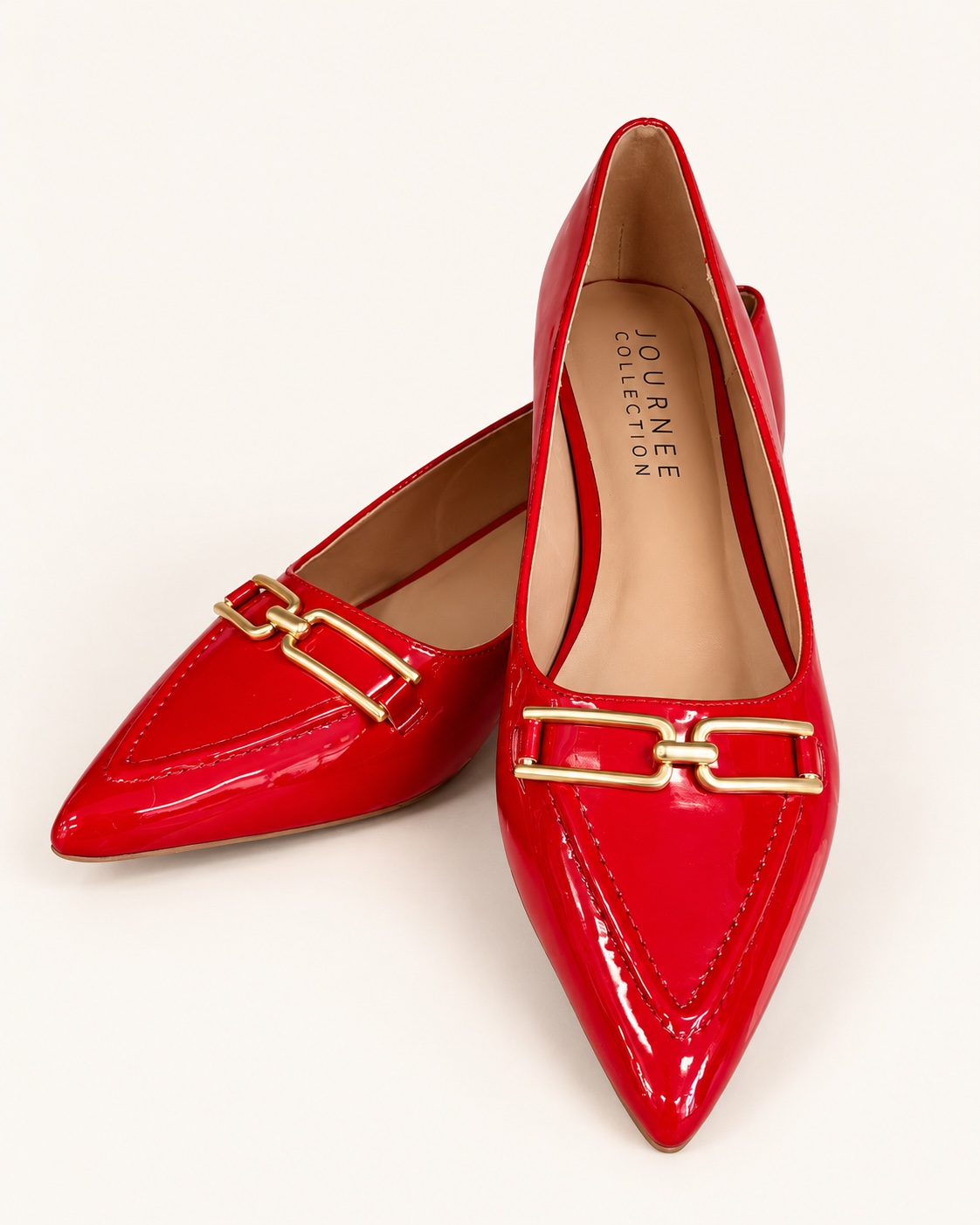 Pair of glossy red pointed-toe shoes with gold-tone linked hardware.