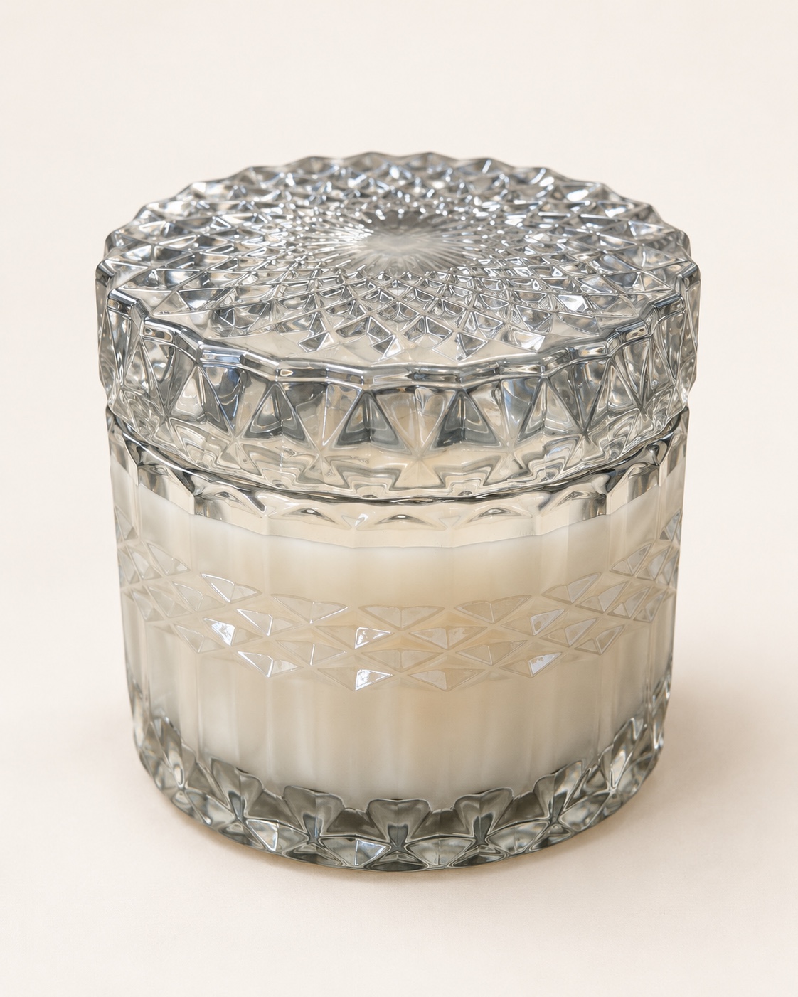 Silver-toned faceted glass candle jar with a matching decorative lid.